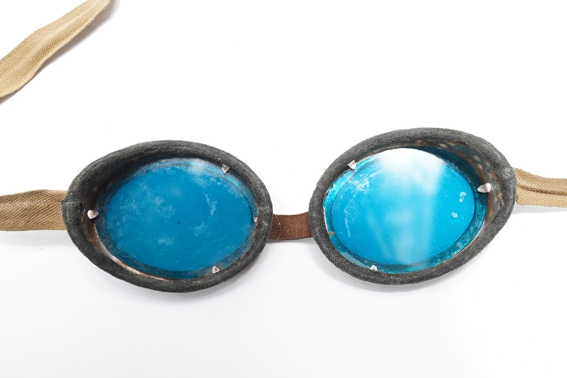 Two pairs of WW2 desert goggles, blue tinted lenses, one with original tin box